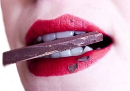 woman biting chocolate
